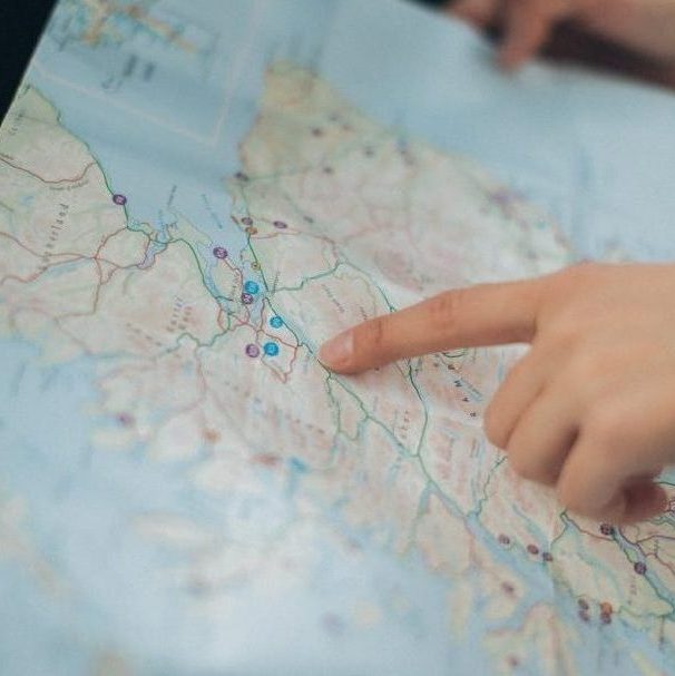 person holding map inside vehicle